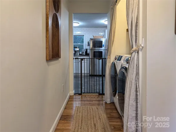 a view of hallway with wooden floor