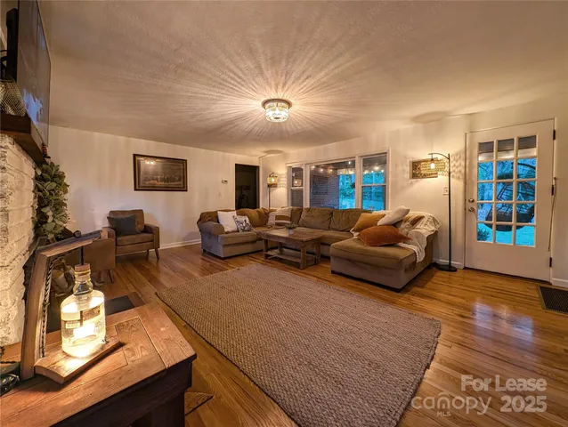 a living room with furniture a flat screen tv and a fireplace