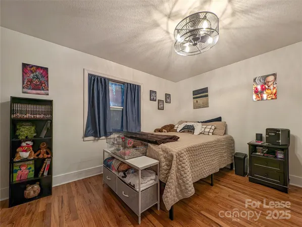 a bedroom with bed and a chandelier