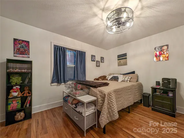 a bedroom with bed and a chandelier