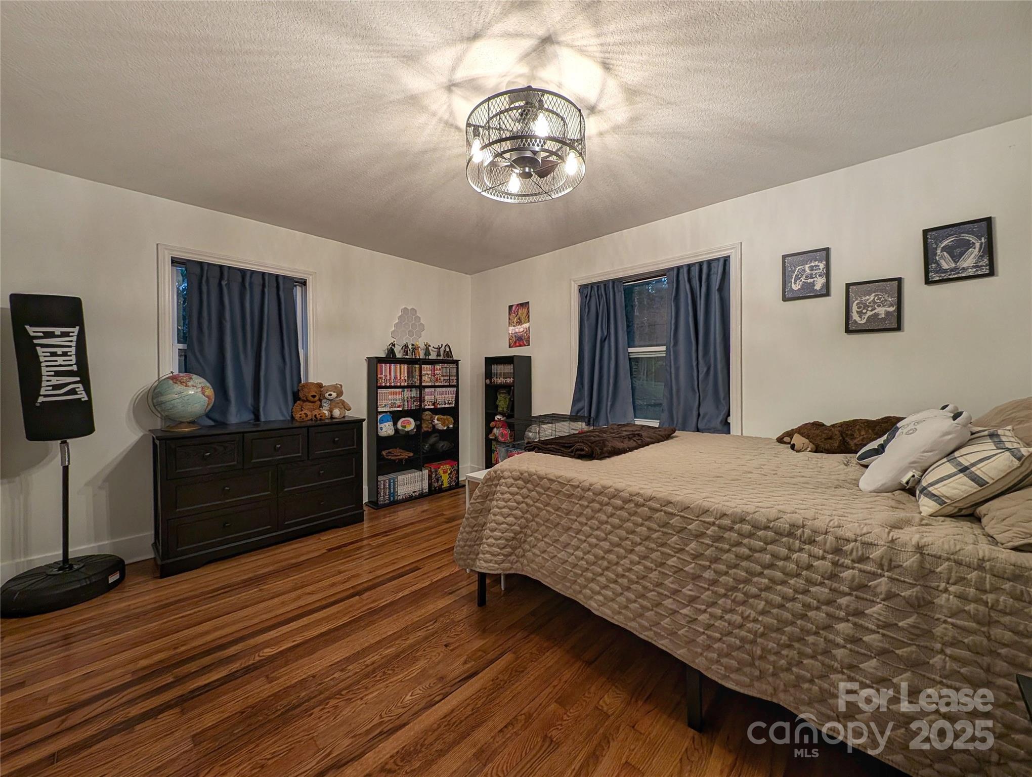 317 Balsam Drive Waynesville, NC 28786 - Photo 36 of 45 a bedroom with a bed and dresser with wooden floor