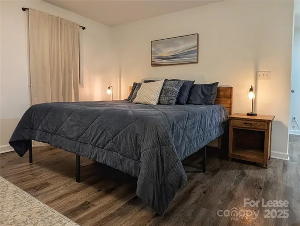 a bedroom with a bed and a television