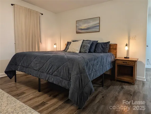 a bedroom with a bed and a television