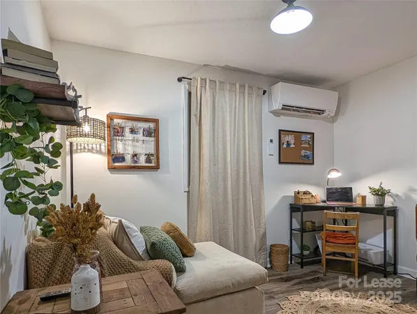 a living room with furniture and a potted plant