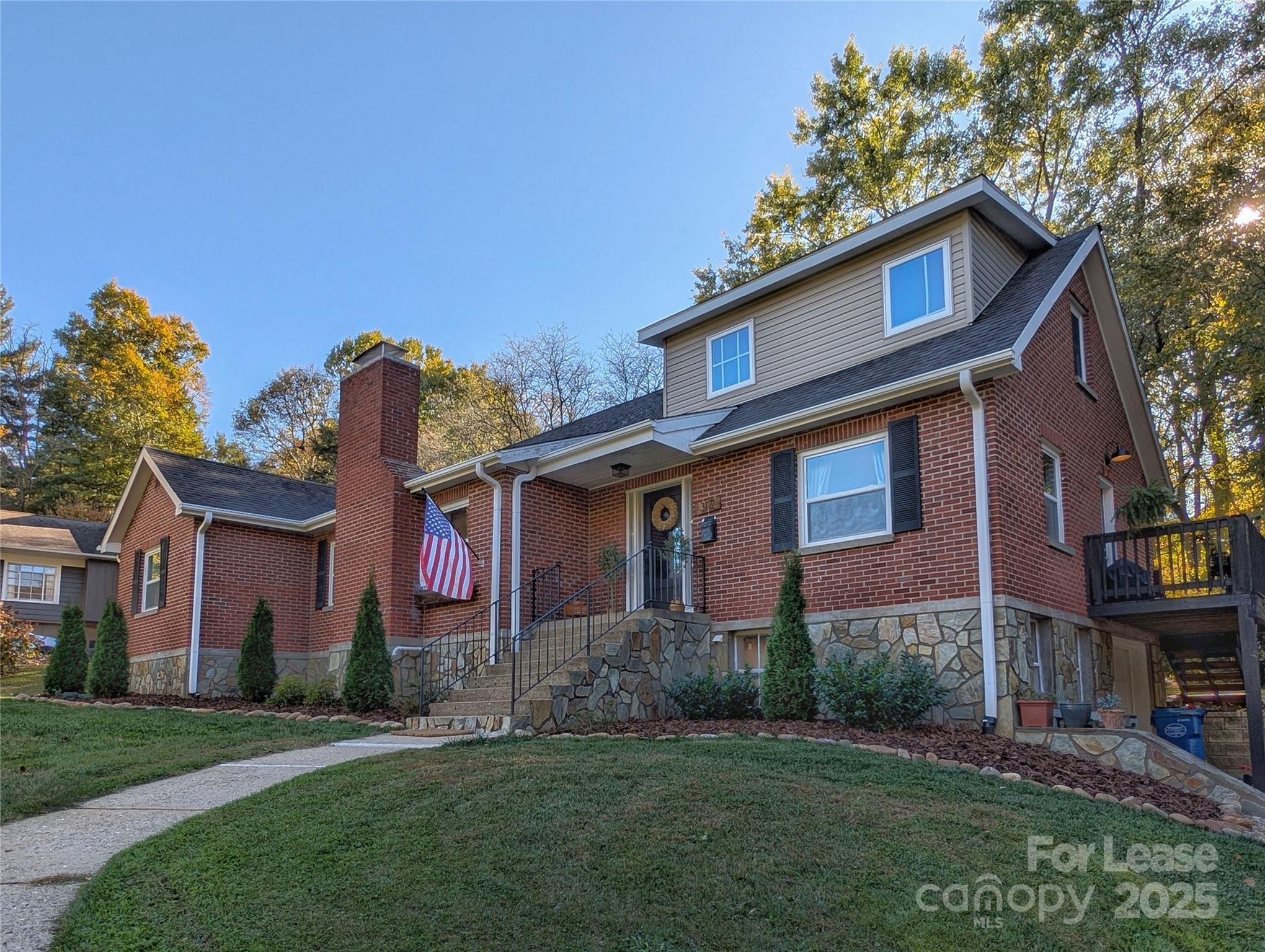 317 Balsam Drive Waynesville, NC 28786 - Photo 5 of 45 a front view of a house with a garden