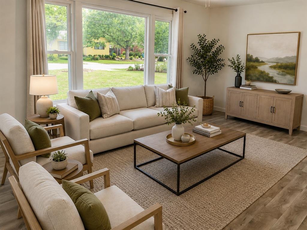 1109 North Howeth Street Gainesville, TX 76240 - Photo 4 of 11 Spacious living area featuring large windows, wood-finish flooring, light-toned walls, and a neutral color palette