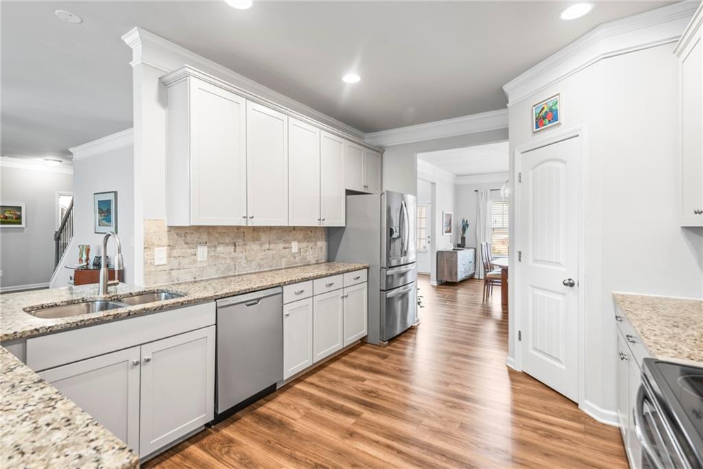 23 Carrington Way Newnan, GA 30265 - Photo 9 of 37 a kitchen with a sink cabinets and wooden floor