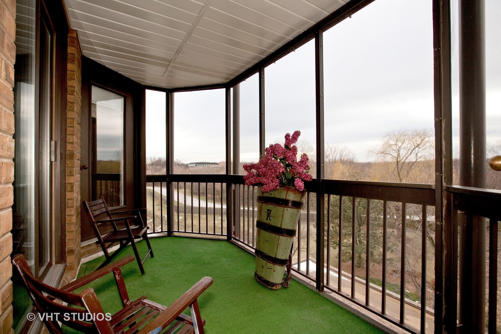 1140 Old Mill Road, Unit 408F Hinsdale, IL 60521 - Photo 11 of 11 a view of a porch with furniture and garden