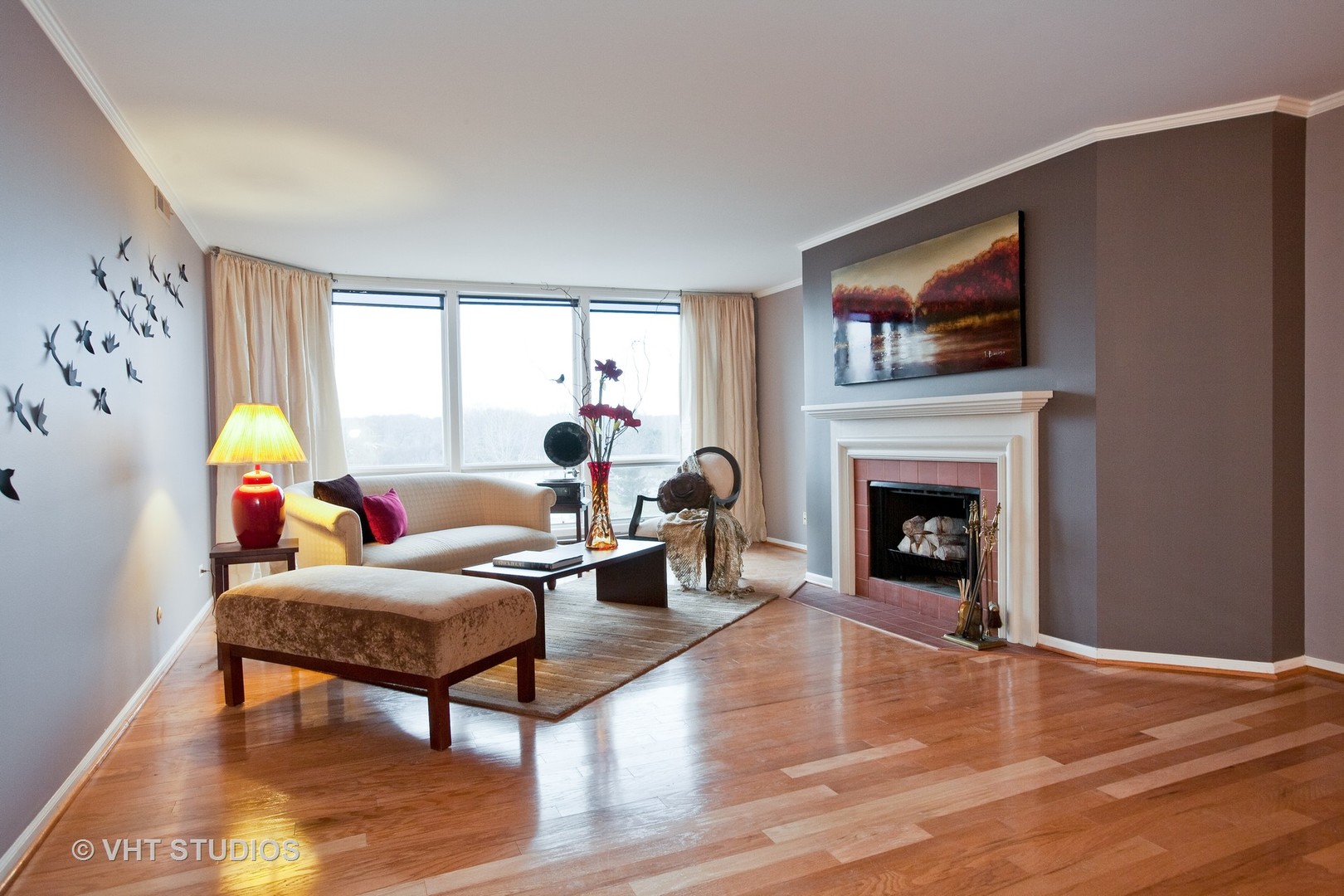 1140 Old Mill Road, Unit 408F Hinsdale, IL 60521 - Photo 2 of 11 a living room with furniture a flat screen tv and a fireplace