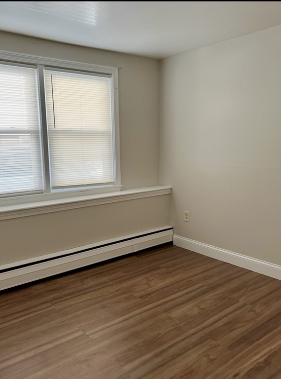 10 Edgemere Road Quincy, MA 02169 - Photo 12 of 25 an empty room with wooden floor and windows
