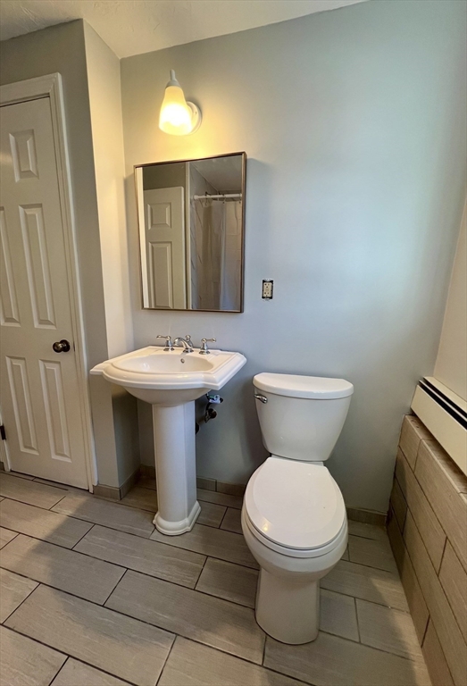 10 Edgemere Road Quincy, MA 02169 - Photo 19 of 25 a bathroom with a toilet a sink and a mirror