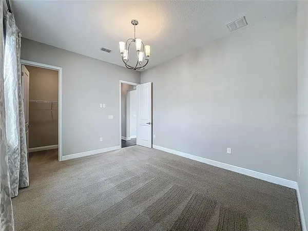 an empty room with a chandelier