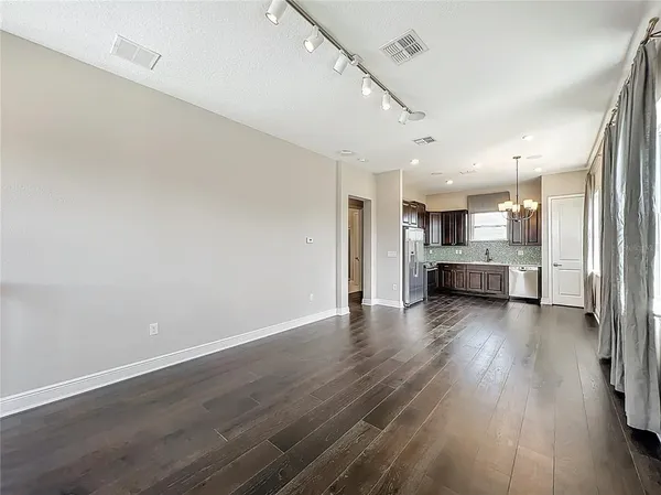 a view of kitchen with furniture and wooden floor