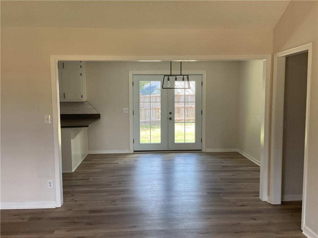 2452 Kilgore Road Buford, GA 30519 - Photo 4 of 16 a view of an empty room with wooden floor and a window