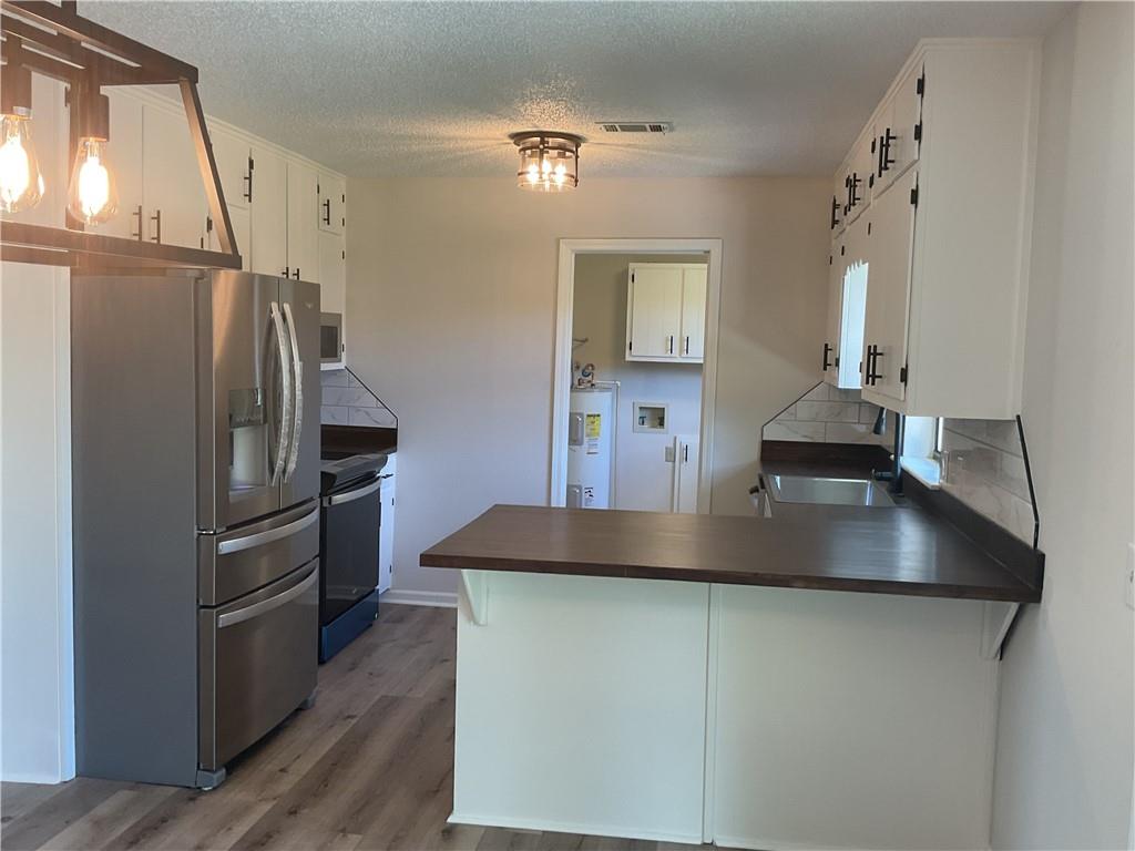 2452 Kilgore Road Buford, GA 30519 - Photo 8 of 16 a kitchen with kitchen island a refrigerator and a stove