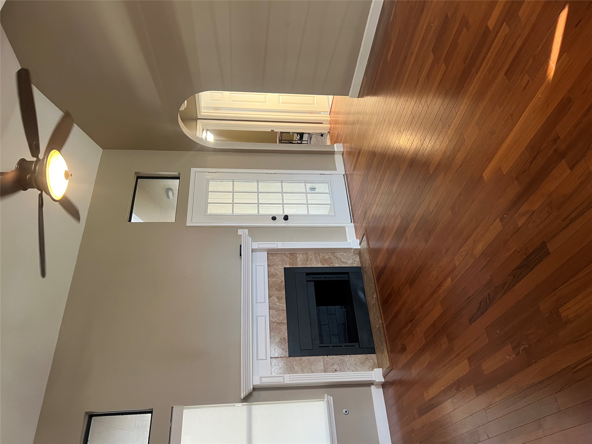 1103 Deepwoods Trail Leander, TX 78641 - Photo 3 of 7 an empty room with wooden floor fireplace and windows