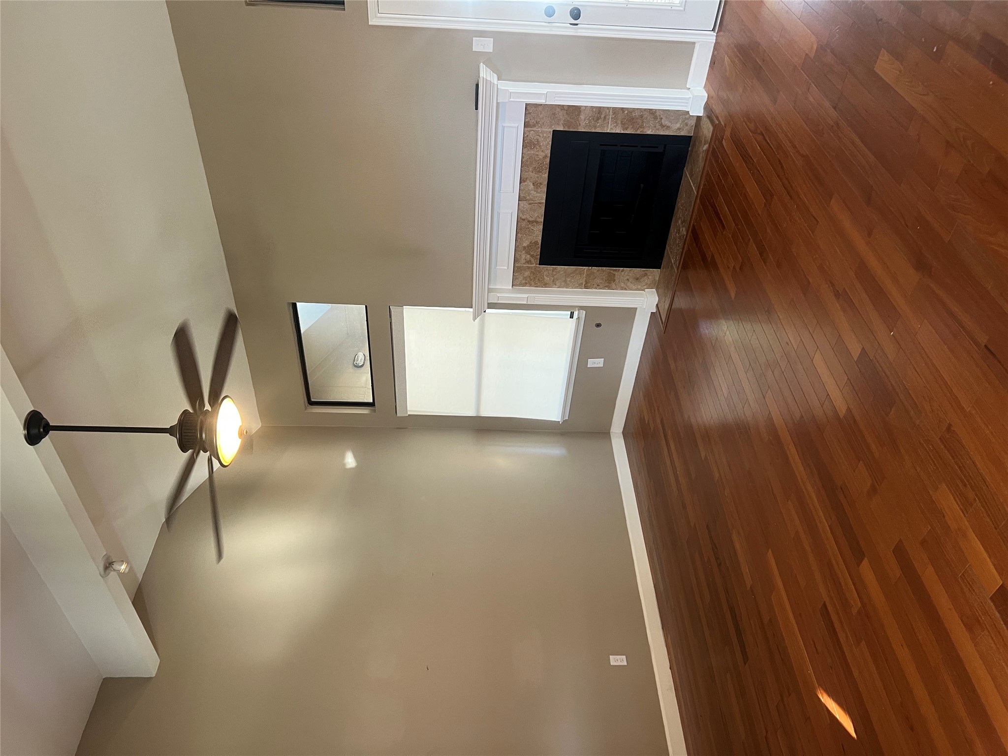 1103 Deepwoods Trail Leander, TX 78641 - Photo 4 of 7 a view of an empty room with wooden floor fireplace and a window