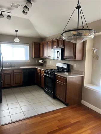 a kitchen with stainless steel appliances granite countertop a sink and a stove