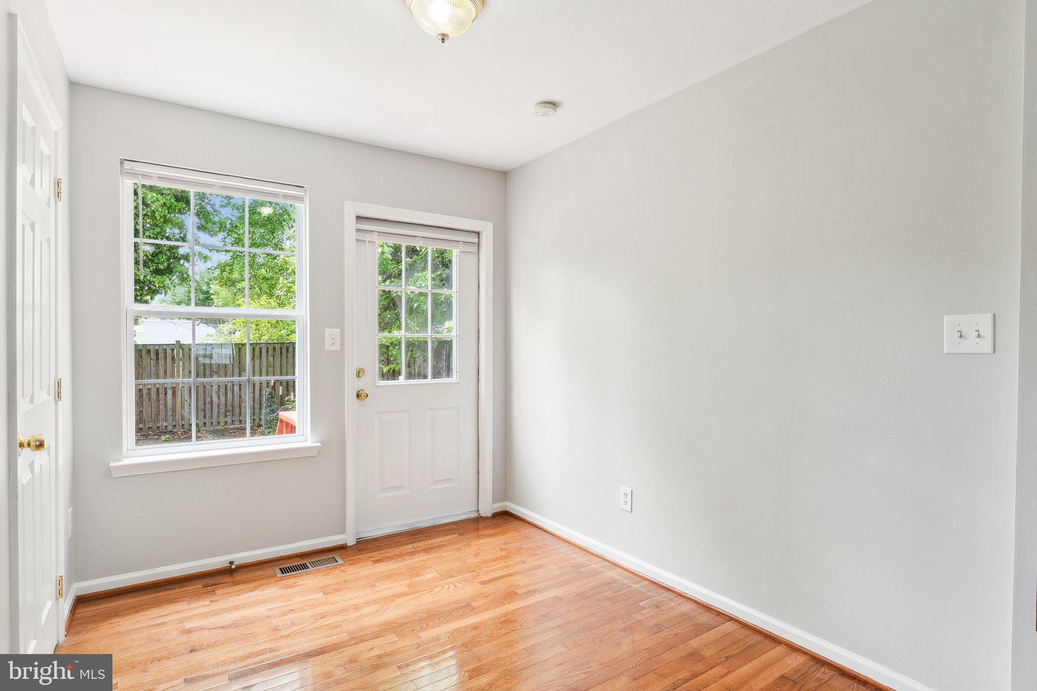 28 Johnson Place Annapolis, MD 21401 - Photo 16 of 35 a view of an empty room with wooden floor and a window