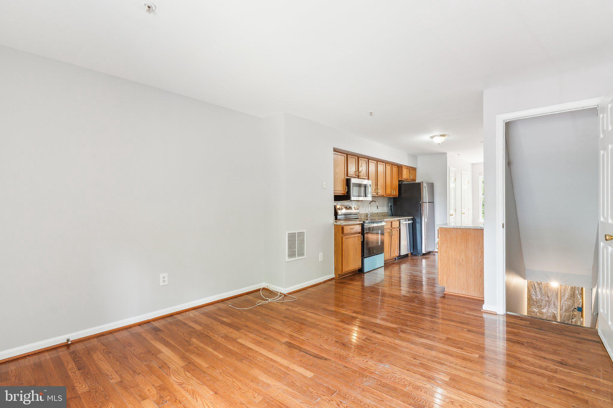 28 Johnson Place Annapolis, MD 21401 - Photo 18 of 35 a big room with wooden floor and a kitchen