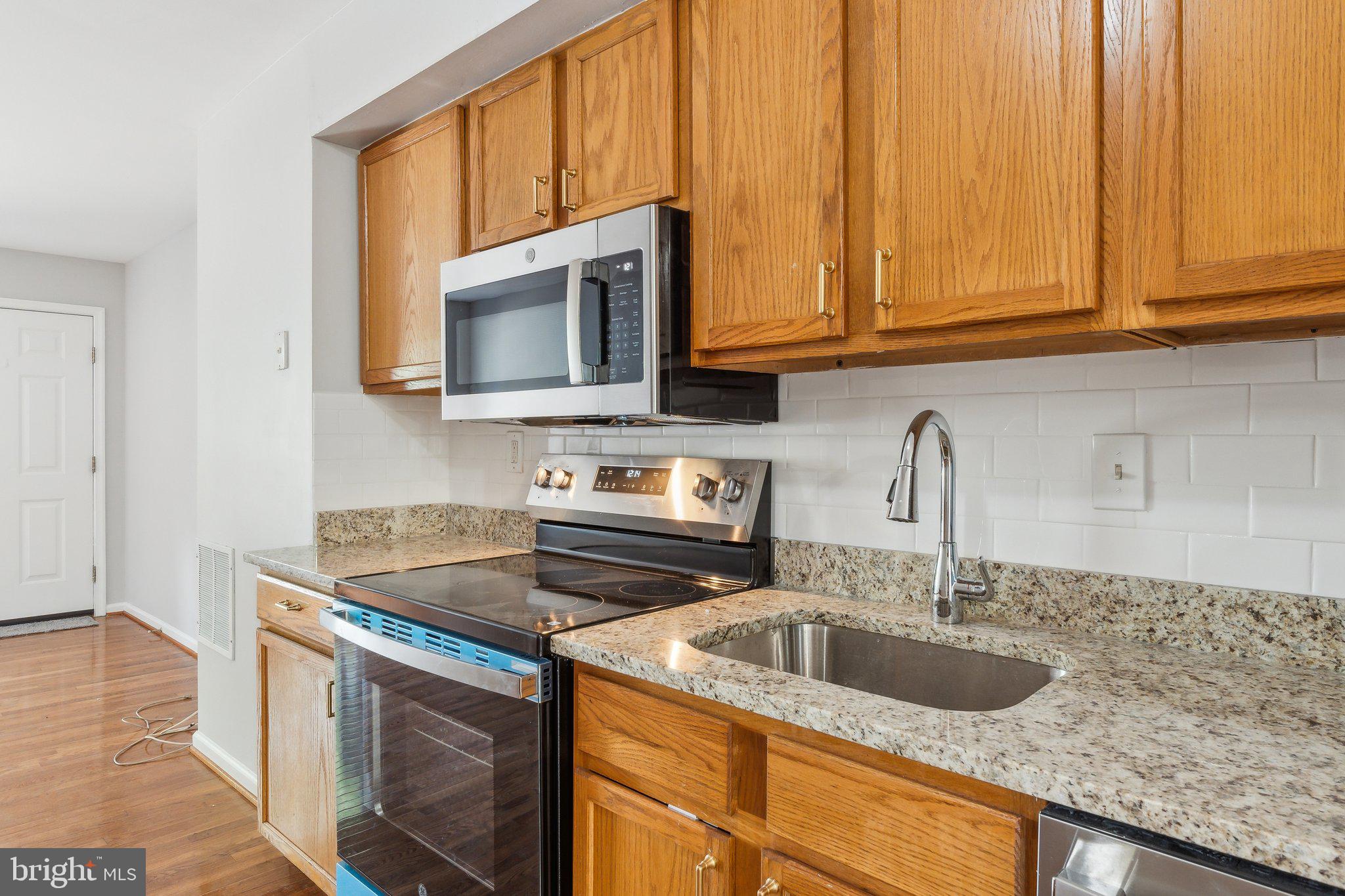 28 Johnson Place Annapolis, MD 21401 - Photo 21 of 35 a kitchen with stainless steel appliances granite countertop a sink stove and microwave