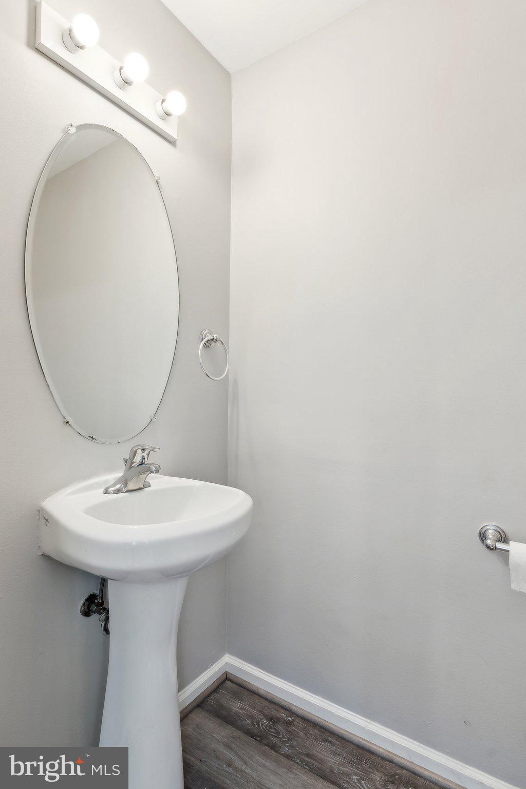 28 Johnson Place Annapolis, MD 21401 - Photo 26 of 35 a bathroom with a sink a mirror and vanity