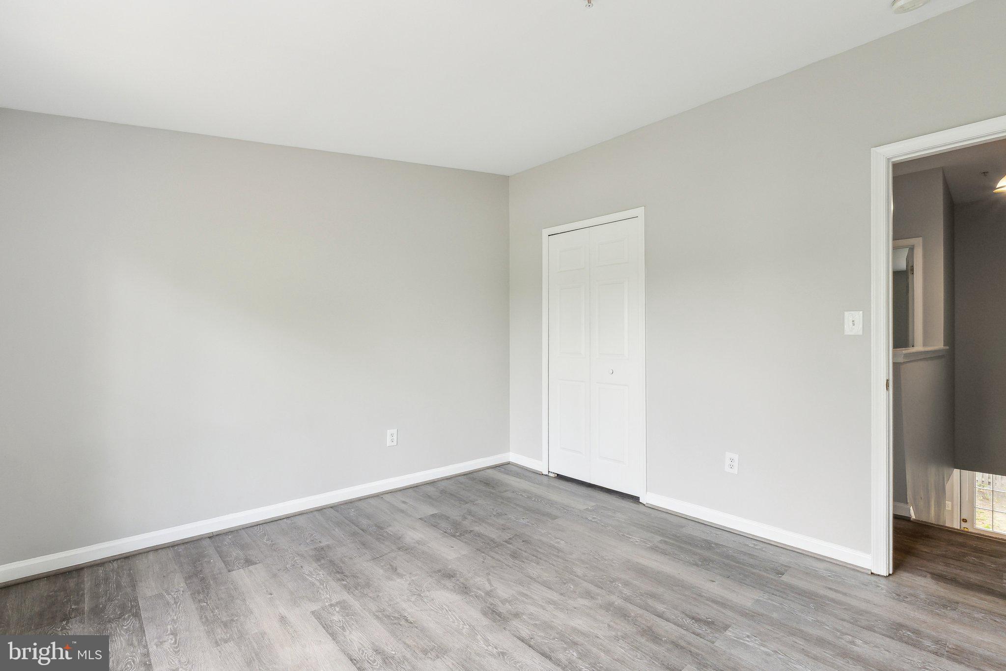 28 Johnson Place Annapolis, MD 21401 - Photo 5 of 35 a view of an empty room with wooden floor and closet