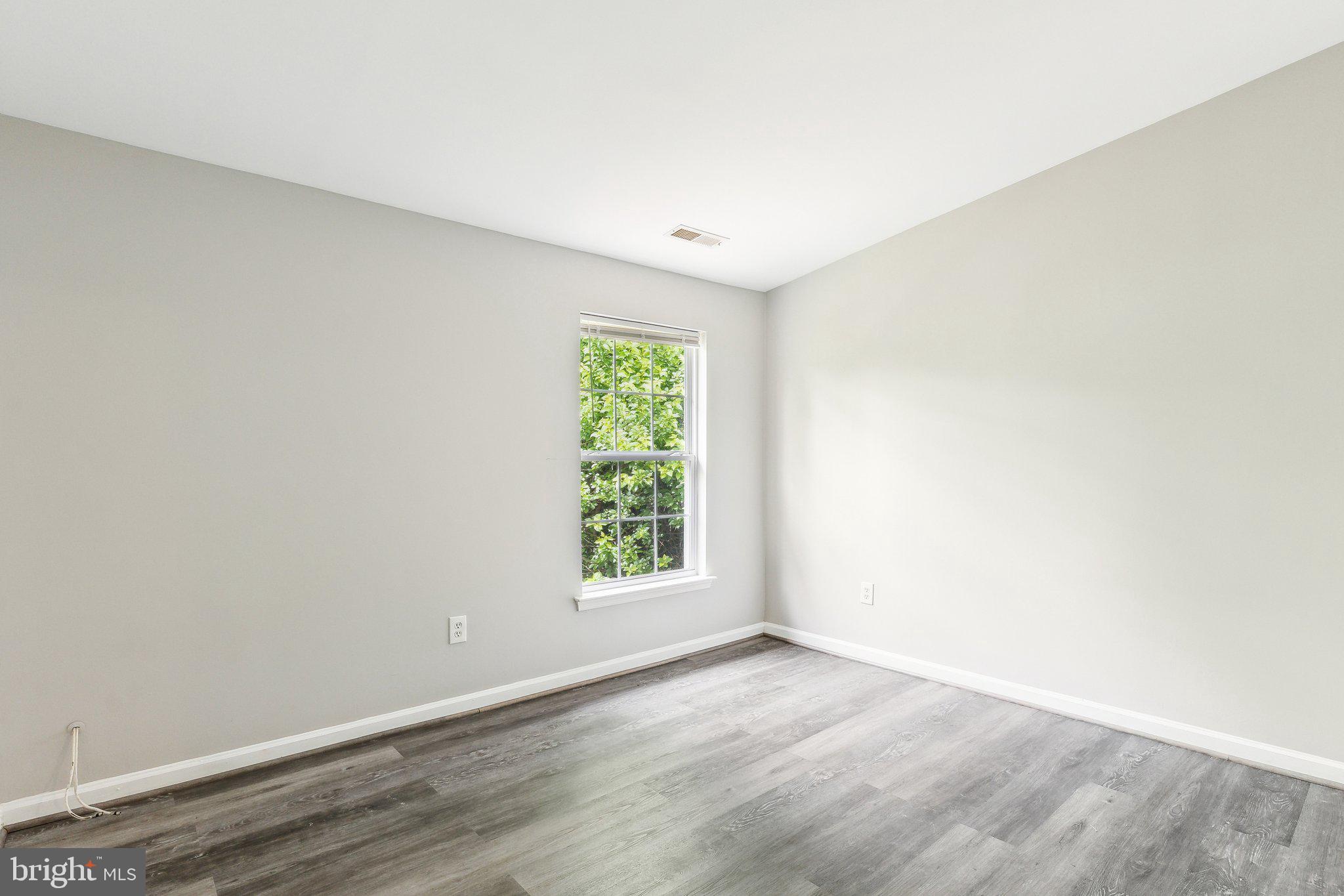 28 Johnson Place Annapolis, MD 21401 - Photo 9 of 35 an empty room with wooden floor and window
