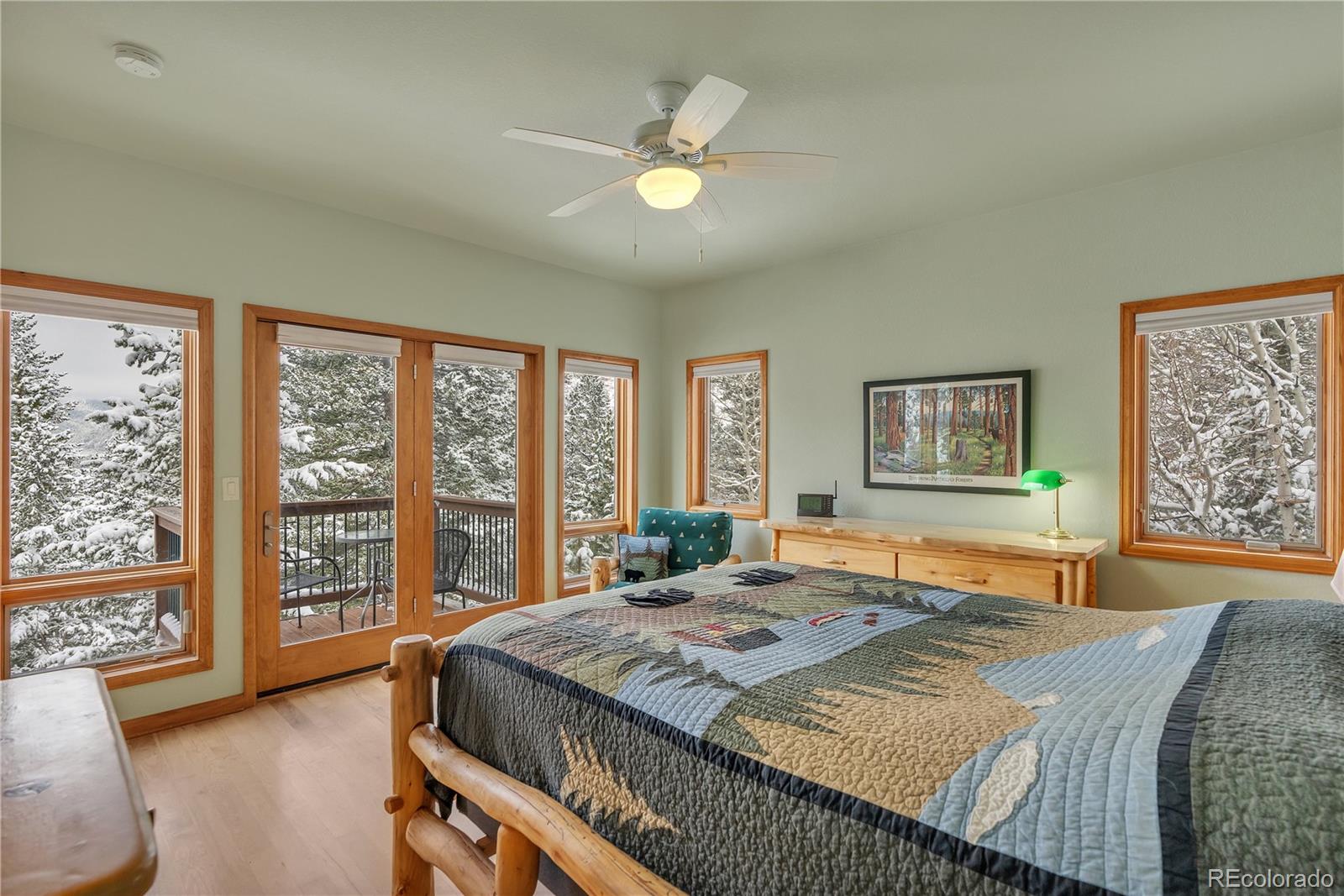 2147 McGraw Ranch Road Estes Park, CO 80517 - Photo 15 of 26 a bedroom with a large bed and a large window