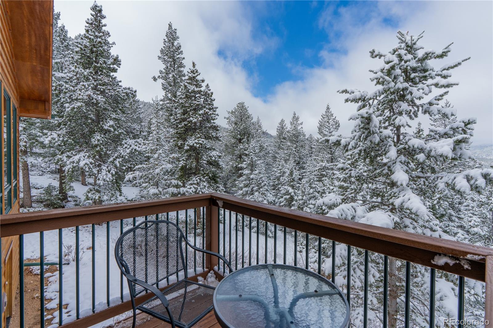 2147 McGraw Ranch Road Estes Park, CO 80517 - Photo 16 of 26 a view of roof deck with wooden fence and trees