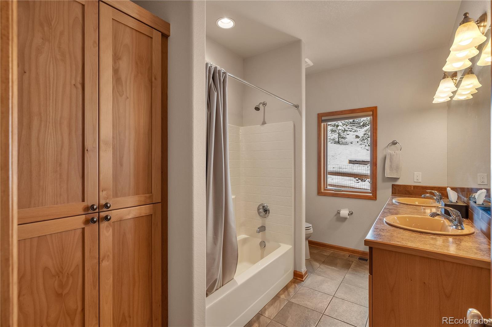 2147 McGraw Ranch Road Estes Park, CO 80517 - Photo 18 of 26 a bathroom with a tub and a shower