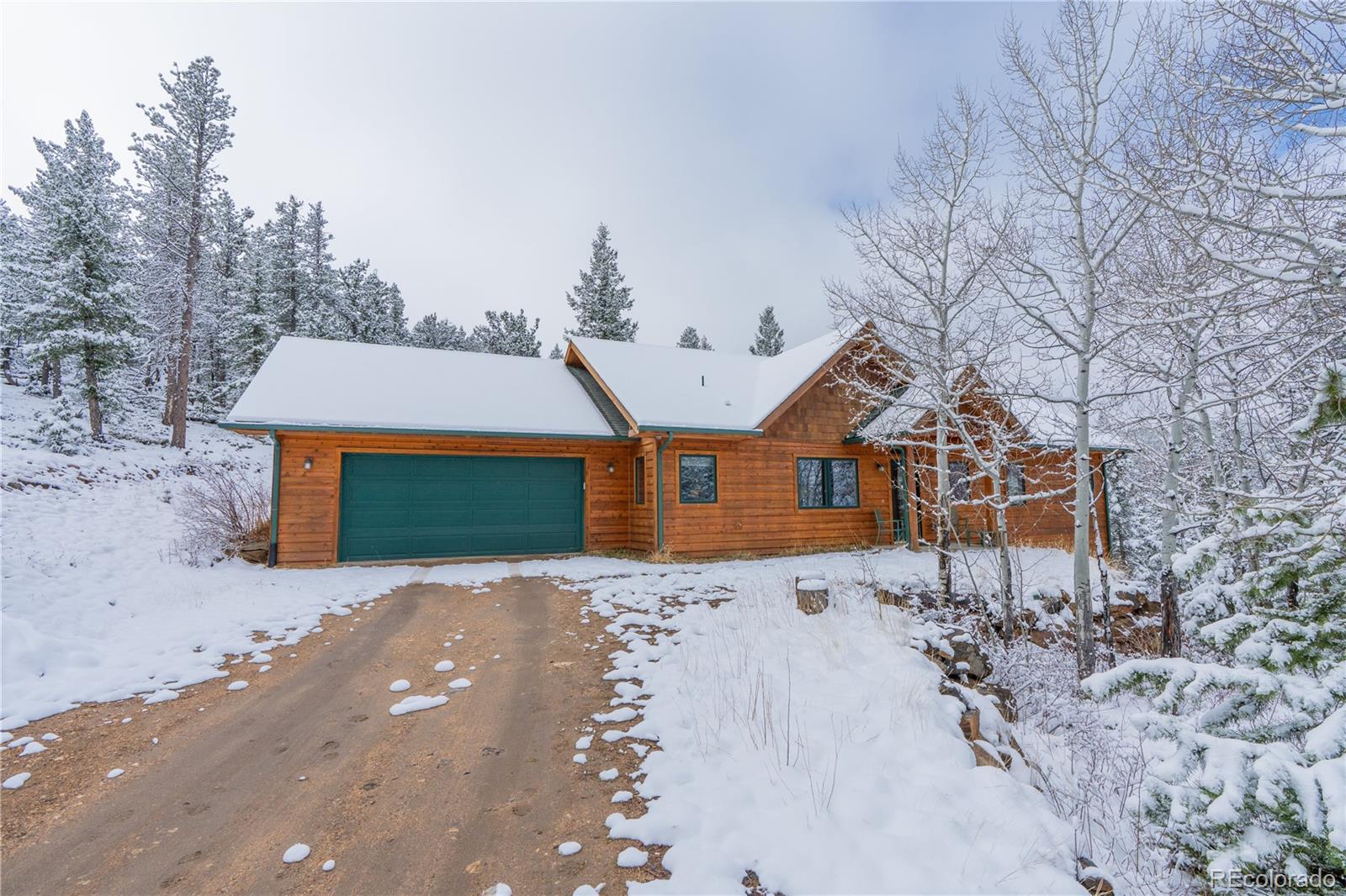 2147 McGraw Ranch Road Estes Park, CO 80517 - Photo 3 of 26 a front view of a house with a yard and garage