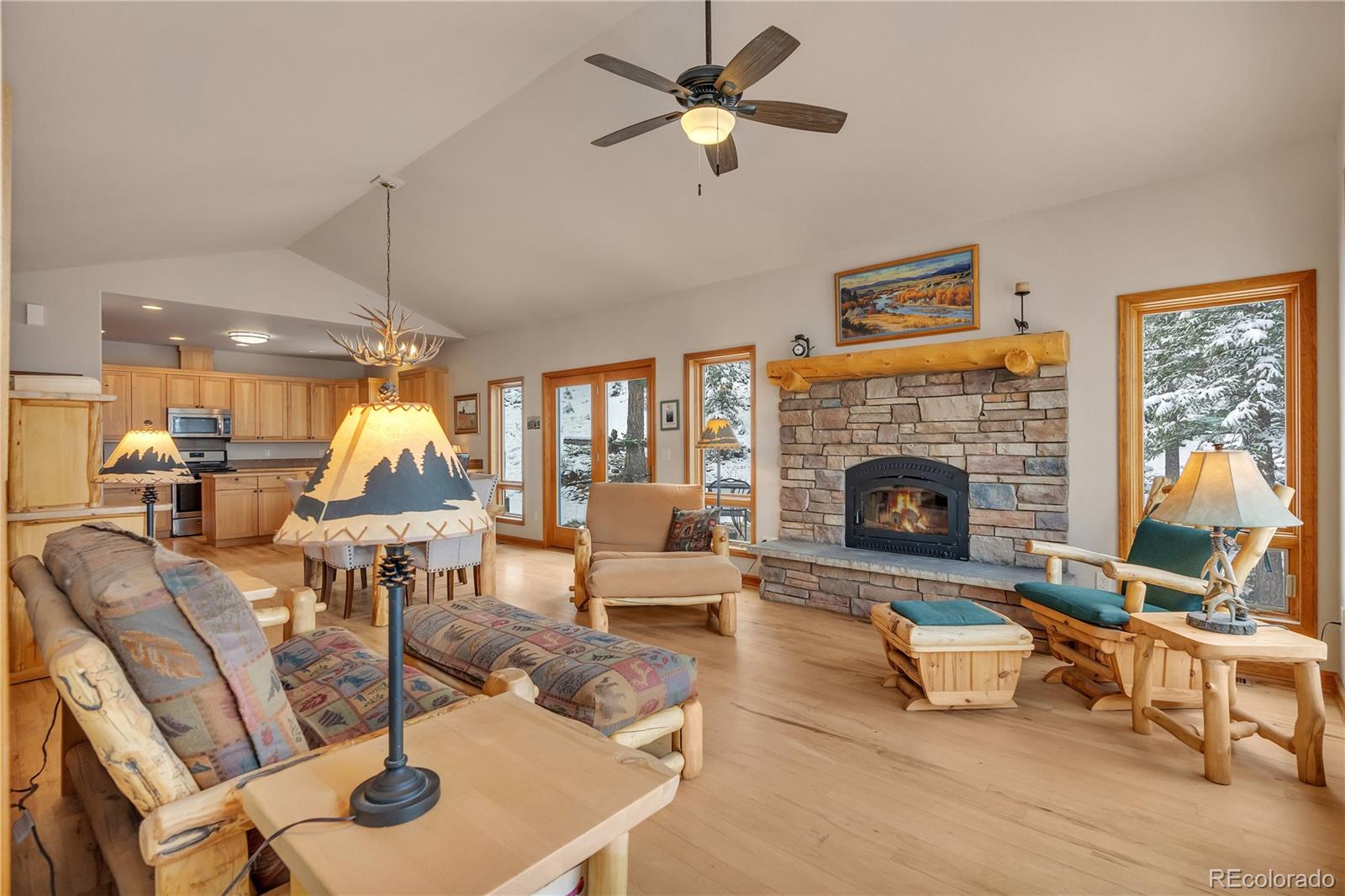 2147 McGraw Ranch Road Estes Park, CO 80517 - Photo 5 of 26 a living room with furniture a fireplace and a table