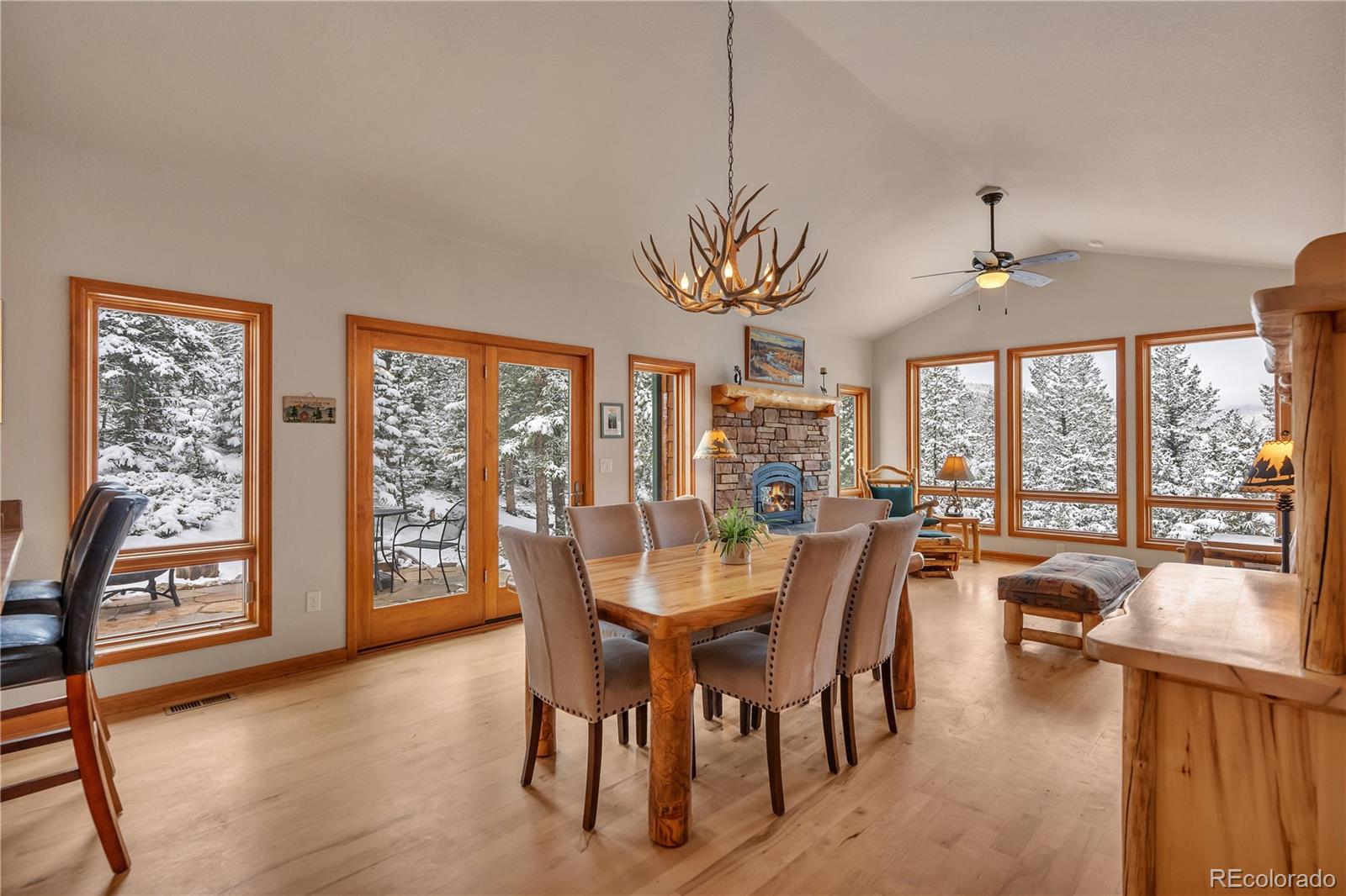 2147 McGraw Ranch Road Estes Park, CO 80517 - Photo 8 of 26 a view of a dining room with furniture large windows and wooden floor