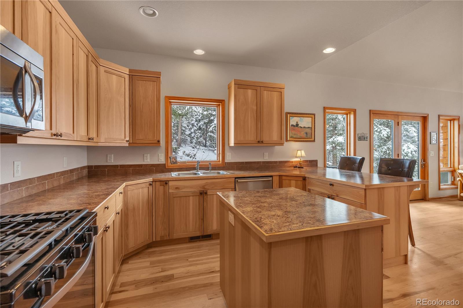 2147 McGraw Ranch Road Estes Park, CO 80517 - Photo 10 of 26 a kitchen with stainless steel appliances granite countertop a sink stove and cabinets