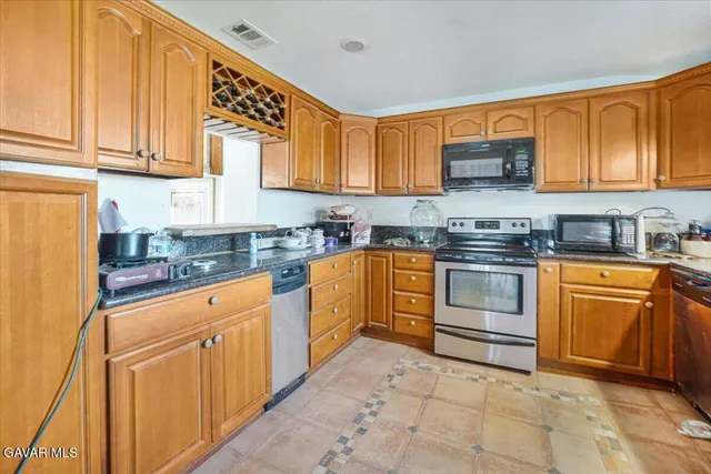 a kitchen with a stove a sink and a refrigerator