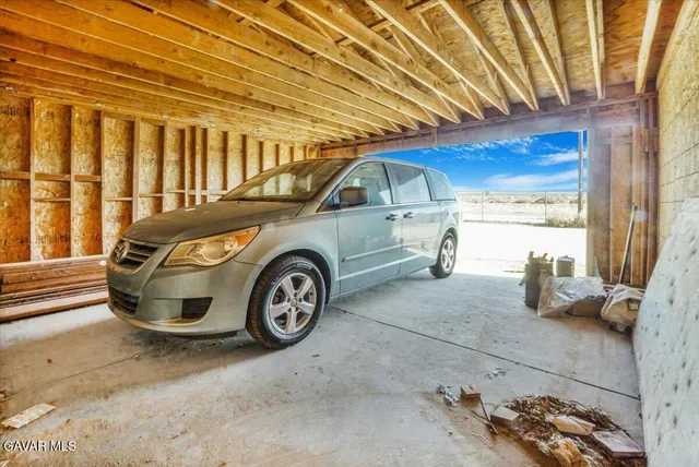 a view of a dining room with furniture large windows and wooden floor
