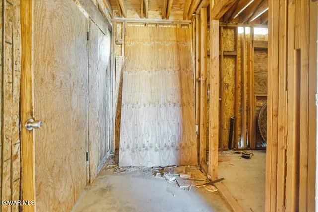 a living room with furniture a clock and a window