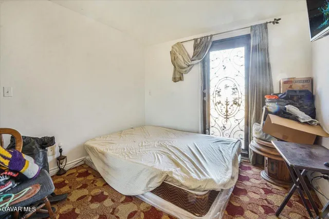 a bed room with a bed and a window