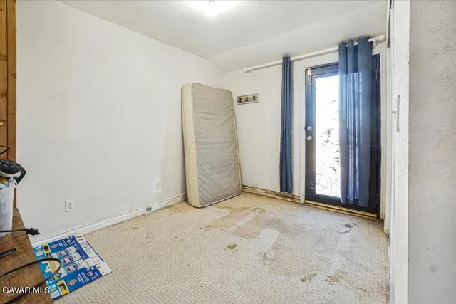a bathroom with a granite countertop toilet sink and mirror