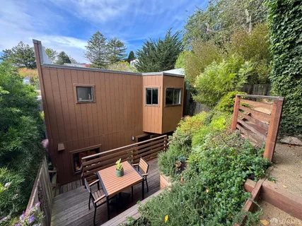 an aerial view of a house with a backyard