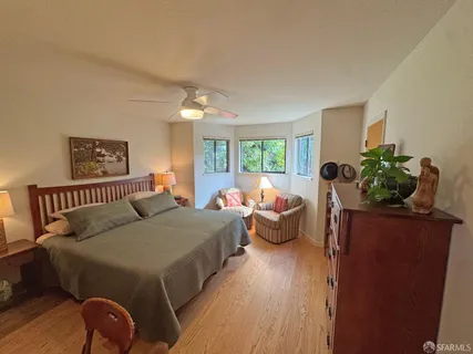 a bed room with a bed and a potted plant