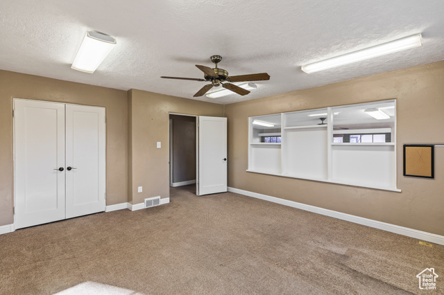 465 North Main Street Richfield, UT 84701 - Photo 28 of 43 Spare room with carpet flooring, visible vents, a textured ceiling, and baseboards