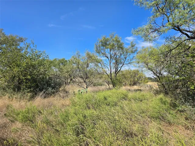 a very nice looking room with a large bed a flat tv screen and a dresser