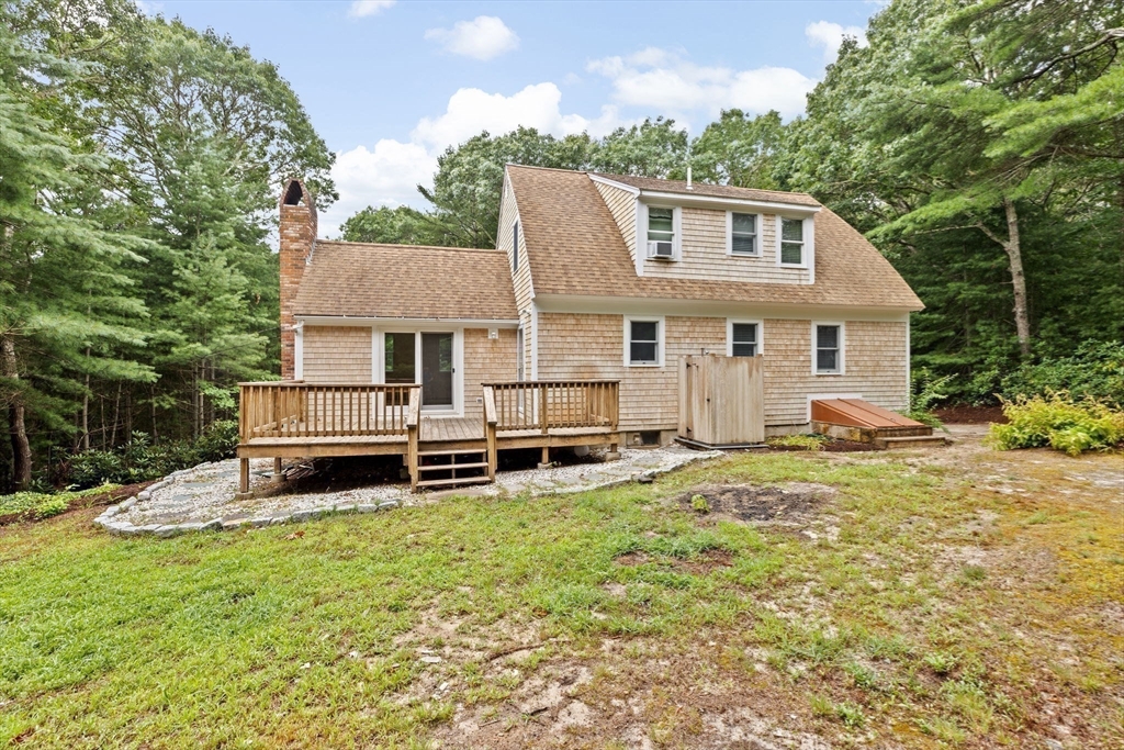 216 Poponessett Road Barnstable, MA 02635 - Photo 16 of 27 a view of a house with a yard and sitting area