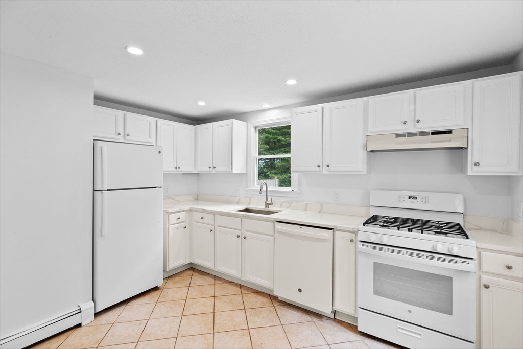 216 Poponessett Road Barnstable, MA 02635 - Photo 8 of 27 a kitchen with cabinets appliances a sink and a counter top space