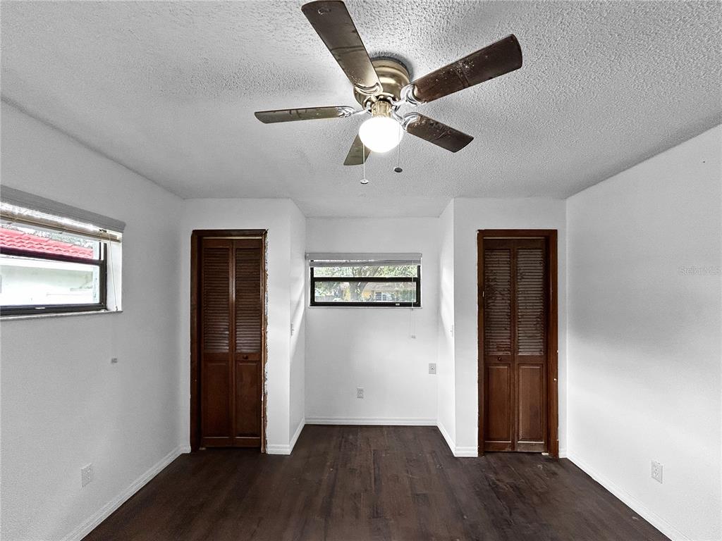 4545 Debbie Lane Lutz, FL 33559 - Photo 12 of 25 wooden floor in an empty room with a window