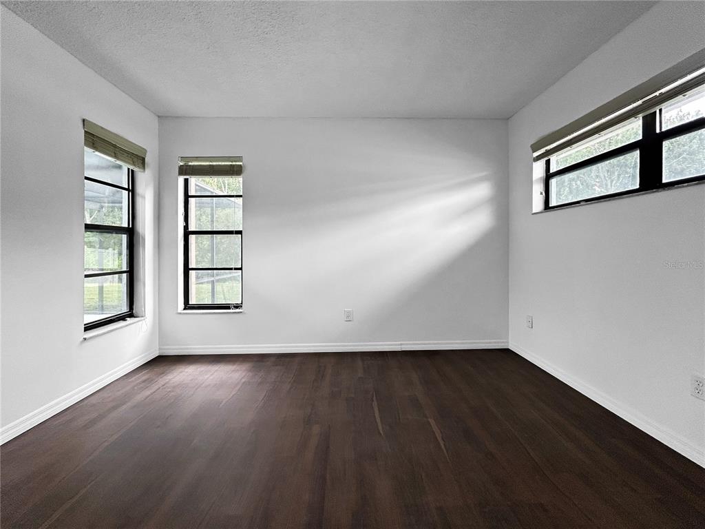 4545 Debbie Lane Lutz, FL 33559 - Photo 13 of 25 wooden floor in an empty room with a window