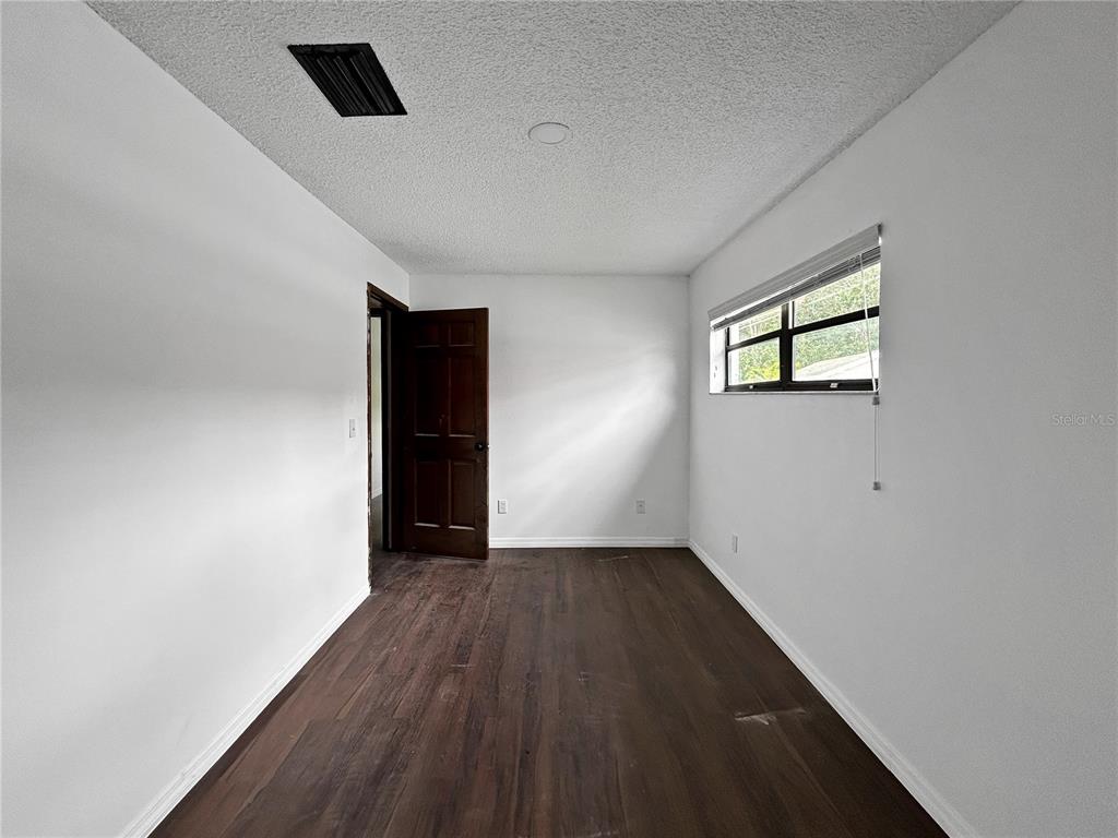 4545 Debbie Lane Lutz, FL 33559 - Photo 14 of 25 an empty room with wooden floor and windows