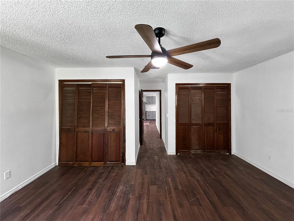 4545 Debbie Lane Lutz, FL 33559 - Photo 15 of 25 a view of a hallway with wooden floor and a ceiling fan